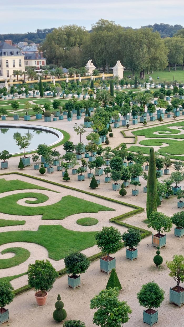 The Art of Drawing Readers In: Your attractive post title goes here Explore the intricate patterns and greenery of the Palace of Versailles gardens from above.